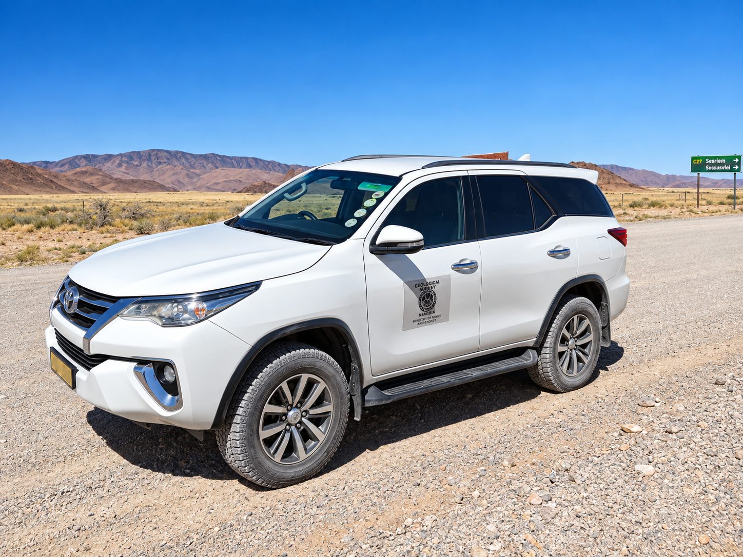 Safari vehicle in a desert landscape